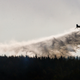 A plane drops flame retardant to extinguish a fire in Chile’s Tambotinaja community, Thursday, Feb. 2, 2017. Image: AP Photo/Esteban Felix